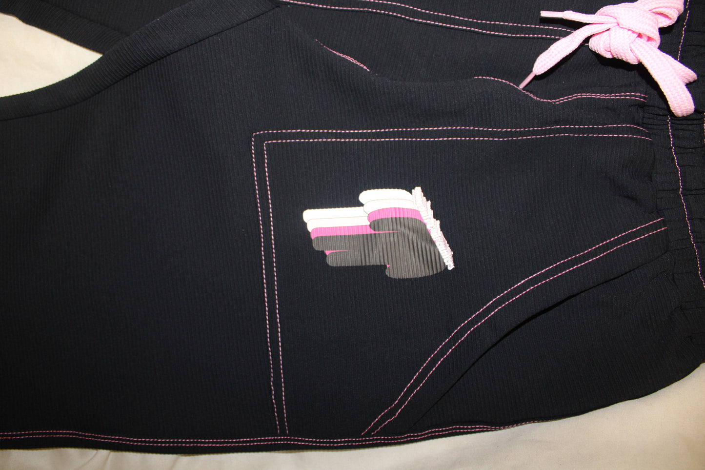 TWIYTC pink and black flared pants