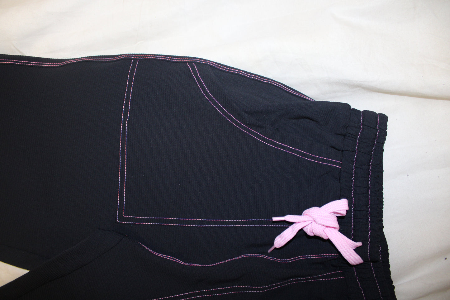 TWIYTC pink and black flared pants