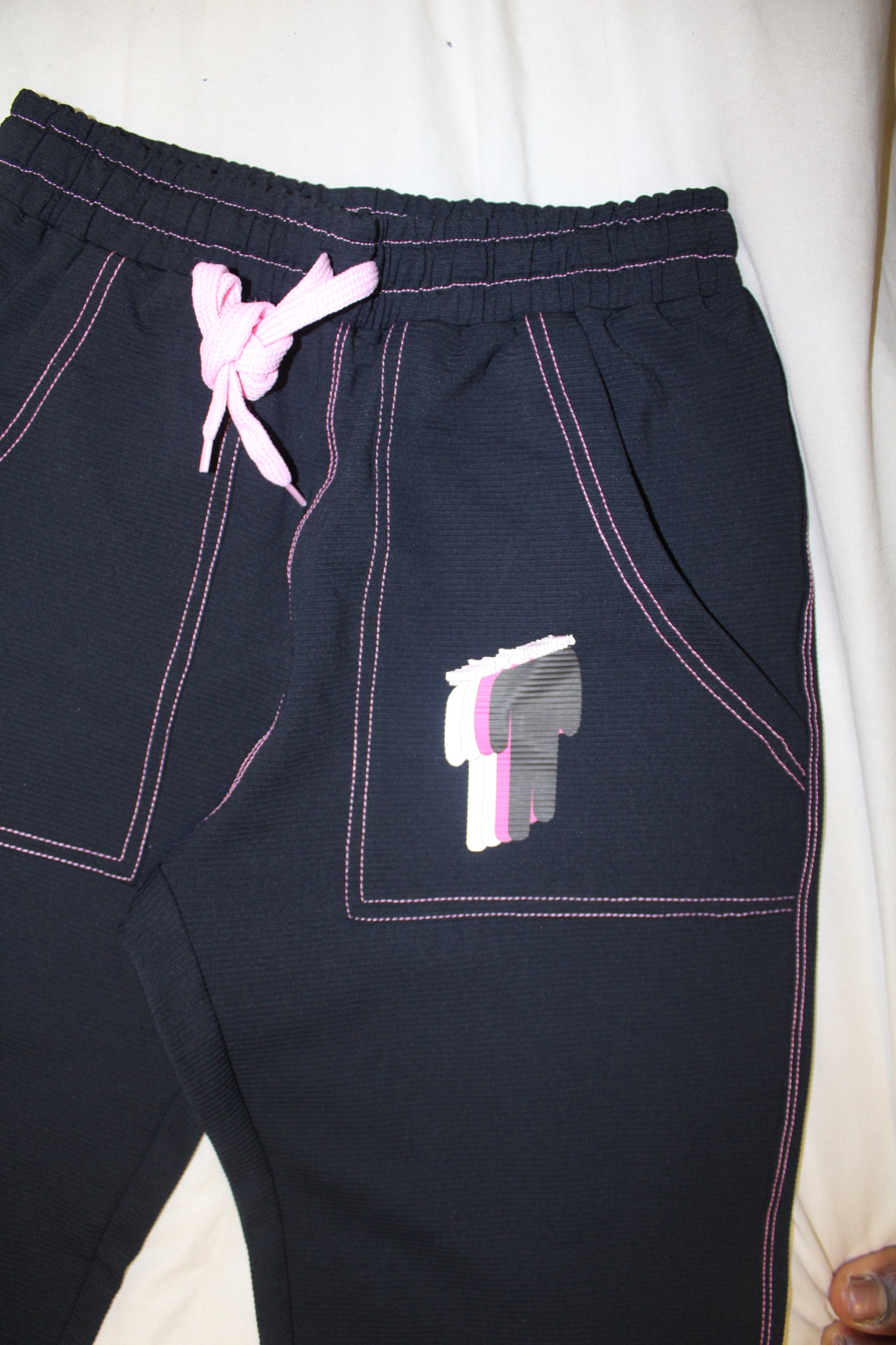 TWIYTC pink and black flared pants